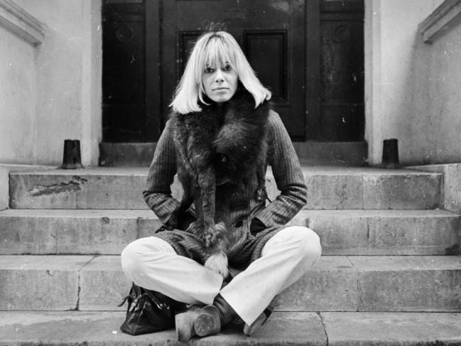 24th October 1968:  Italian-born German actress Anita Pallenberg sits cross-legged on a flight of stone steps with her hands in her pockets.  (Photo by Larry Ellis/Express/Getty Images)