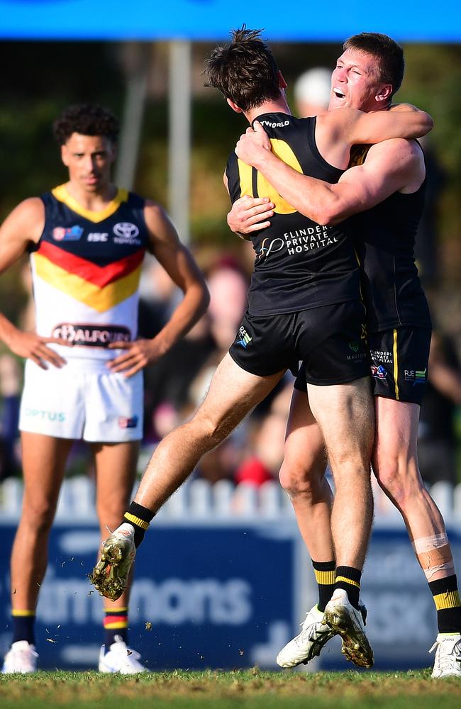 Luke Partington embraces Glenelg teammate Luke Reynolds after the Tigers held on to beat Adelaide in the top-of-the-table clash last weekend. Picture: Mark Brake/Getty Images