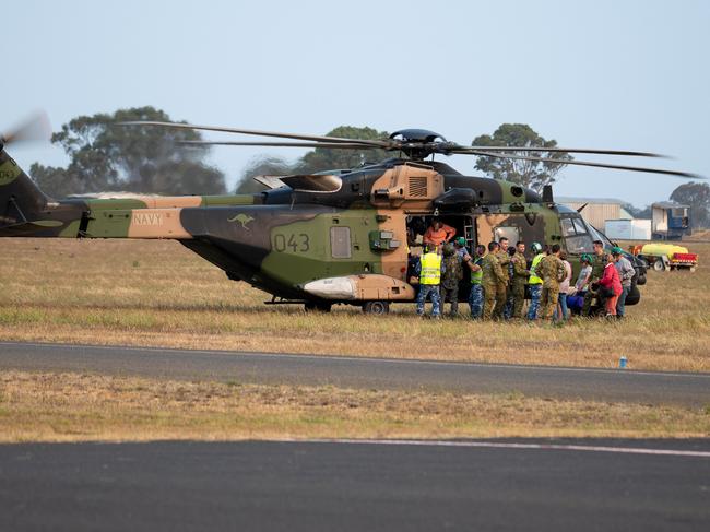 Defence, Search and Rescue Aircraft and evacuees transiting Bairnsdale Airport.