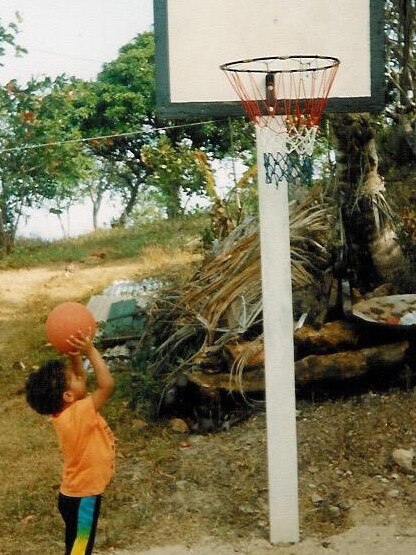 Having a ball: Mills practising his skills as a toddler