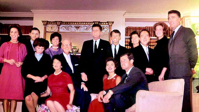 Matriarch Rose Fitzgerald Kennedy, pictured left sitting in the red dress, wrote about her sons John, pictured centre, standing, and Robert, pictured to John’s left. Picture: News Corp