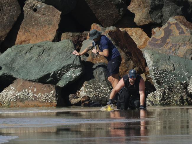 Police dive crews search for clues near the scene of the fatal attack. Picture: Lachie Millard