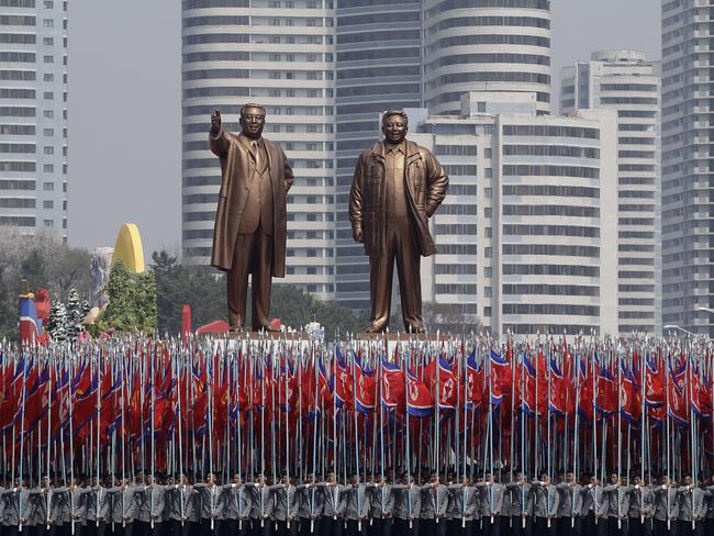 University students carry North Korean national flags and two bronze statues of the late leaders Kim Il-sung and Kim Jong-il during a military parade in Pyongyang. Picture: Wong Maye-E/AP