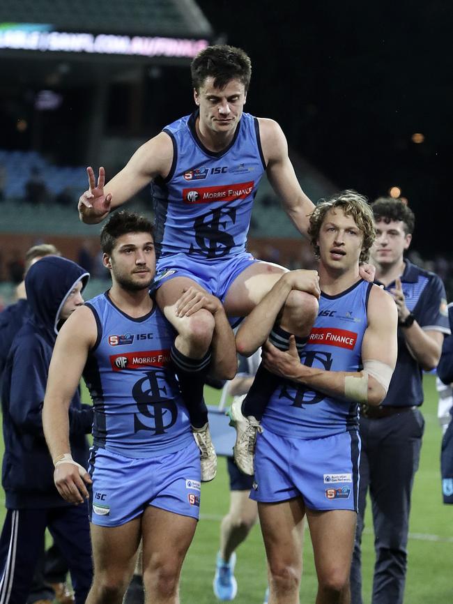 Sturt’s Jack Stephens is chaired off in his last game by James Battersby and Tom Harms. Picture: SARAH REED