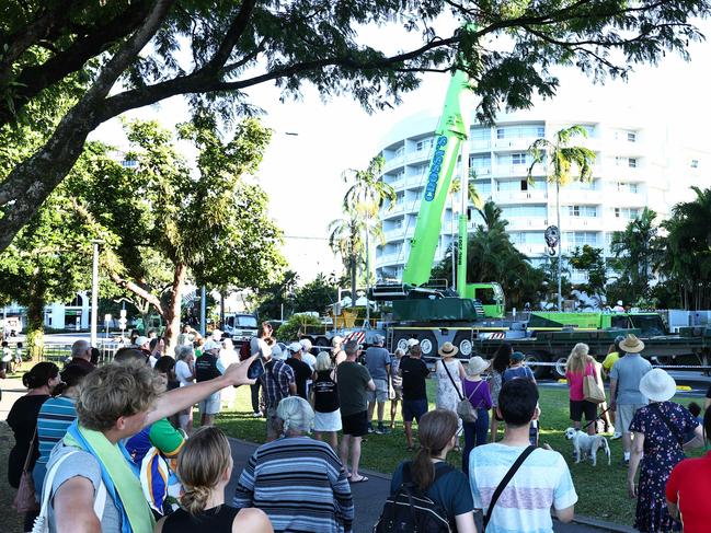 A large crowd gathers to watch a crane remove the wreckage of a Robinson R44 helicopter off the rooftop of the Double Tree Hilton hotel onto the Cairns Esplanade below. Picture: Brendan Radke