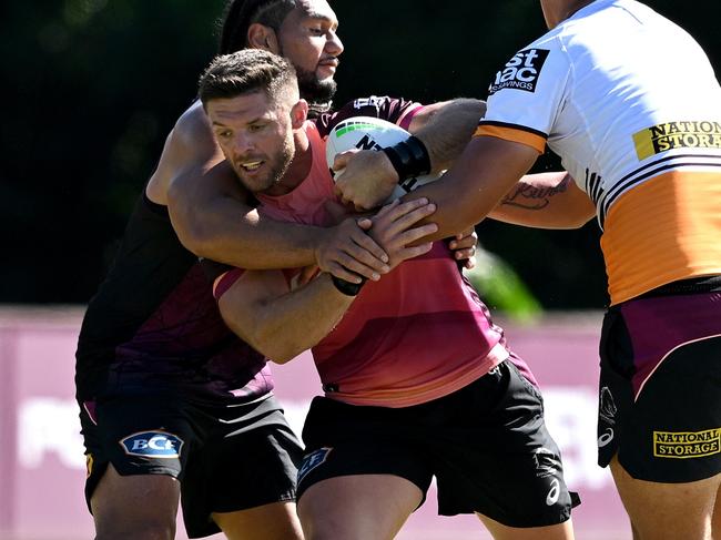 BRISBANE, AUSTRALIA - APRIL 30: Corey Jensen takes on the defence during a Brisbane Broncos NRL training session at Clive Berghofer Field on April 30, 2024 in Brisbane, Australia. (Photo by Bradley Kanaris/Getty Images)