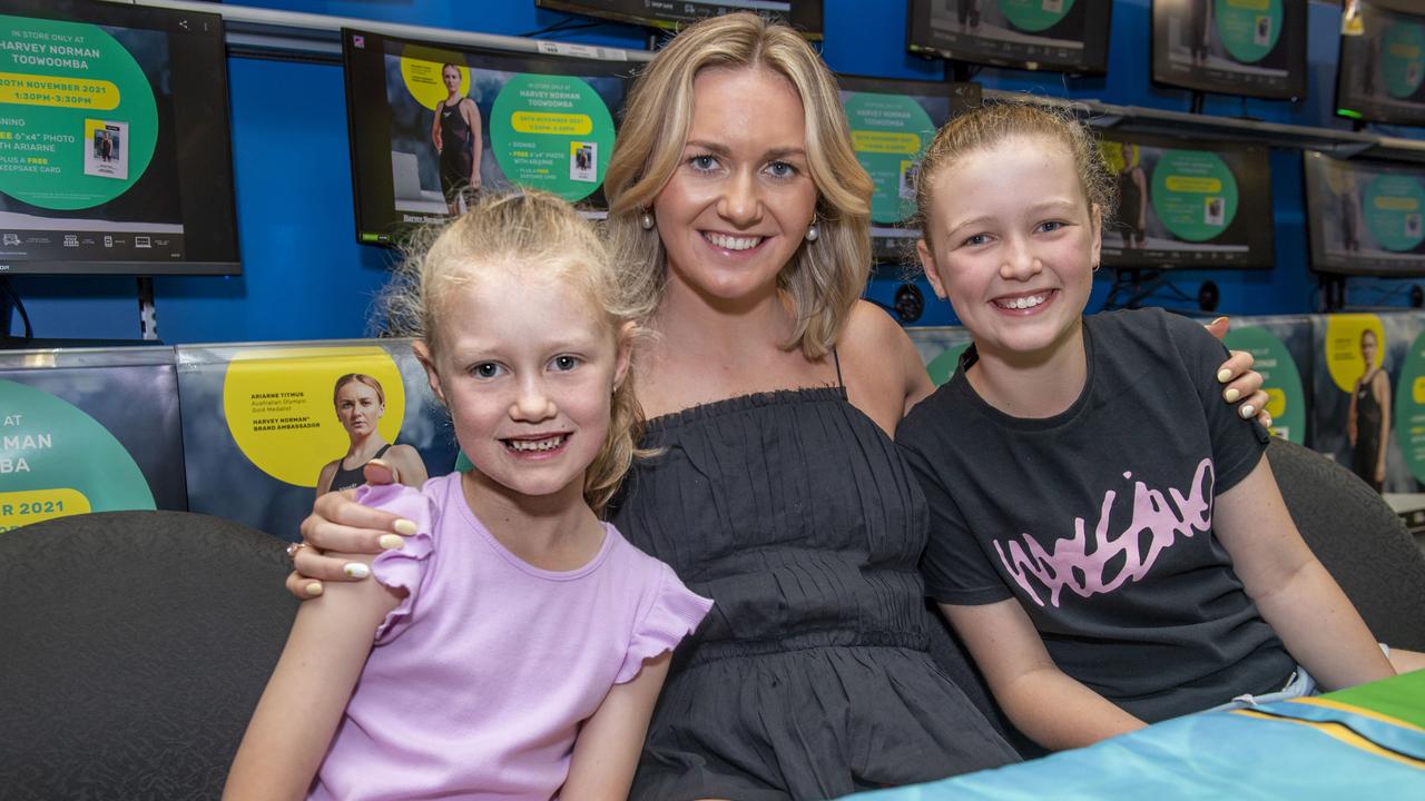 (from left) Maggie Stevens, Ariarne Titmus and Charlotte Stevens. The Stevens sisters are from the Allora swim club. Fans meet Harvey Norman Brand Ambassador and Olympic Gold Medalist Ariarne Titmus. Saturday, November 20, 2021. Picture: Nev Madsen.