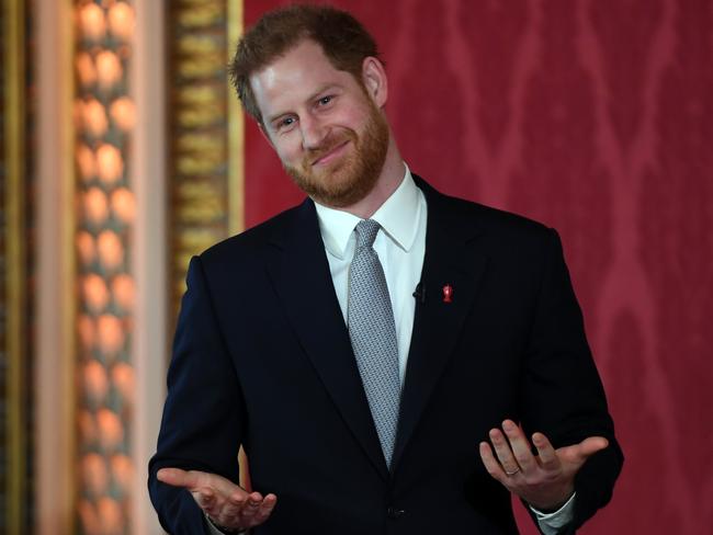 Royal watchers were delighted to see the smile back on Prince Harry’s face inside Buckinghman Palace at what could have been his last event as a full-time royal. Picture: AP