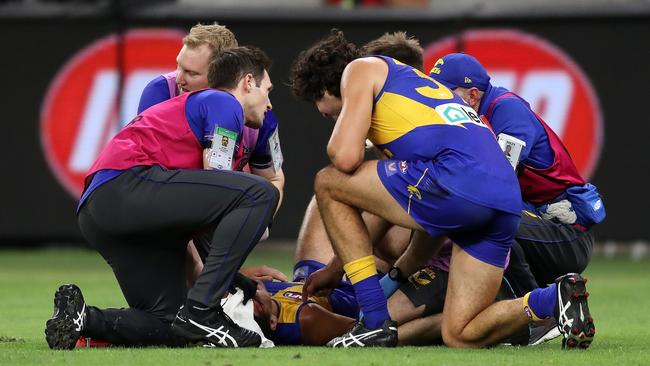 Tom Cole lies on the ground after clashing heads with Josh Rotham. (Photo by Will Russell/AFL Photos via Getty Images)