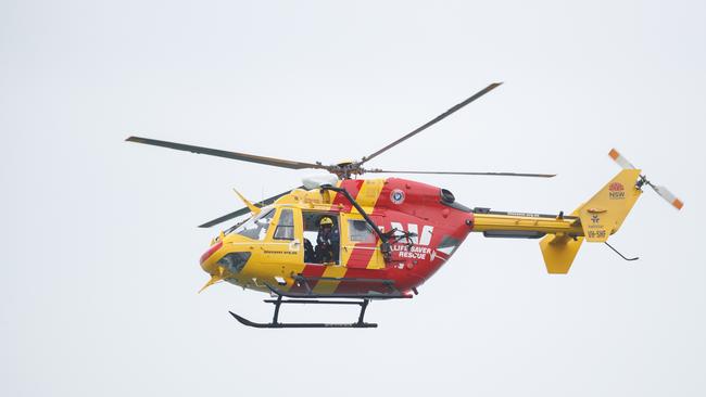 DAILY TELEGRAPH. The Westpac Rescue Helicopter patrols beaches at The Entrance in the search for a missing 11 year old boy swept out to sea last night while wading across the channel at The Entrance on the Central Coast. Monday 04/11/2024. Picture by Max Mason-Hubers