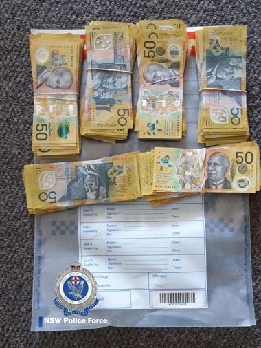 Cash, cannabis and spray paint cans were allegedly seized by police from the property. Picture: NSW Police