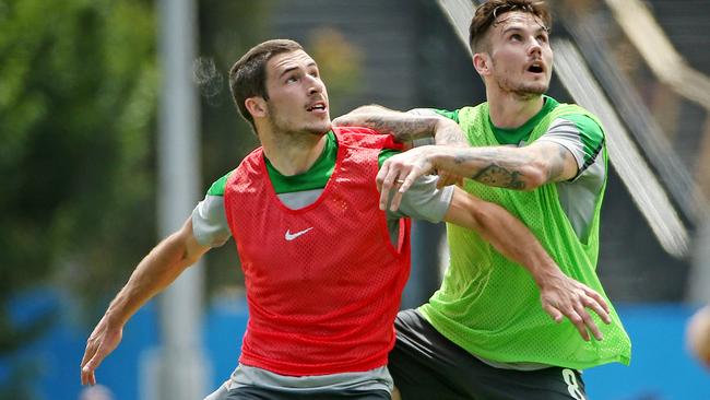 Socceroos train ahead of their Asian Cup opener at Olympic Park, (L) Mathew Leckie and (R) Chris Herd tangle. Melbourne. 4th January 2015. Picture: Colleen Petch.