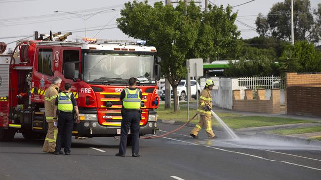 Firefighters hose down the scene. Picture: Sarah Matray