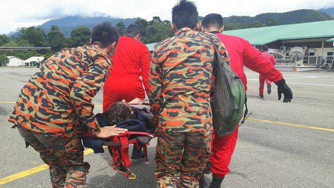 Tasmanian Andrew Gaskell being carried from a Bomba M17 at Mulu airport. Picture: Sarawak Fire and Rescue Department