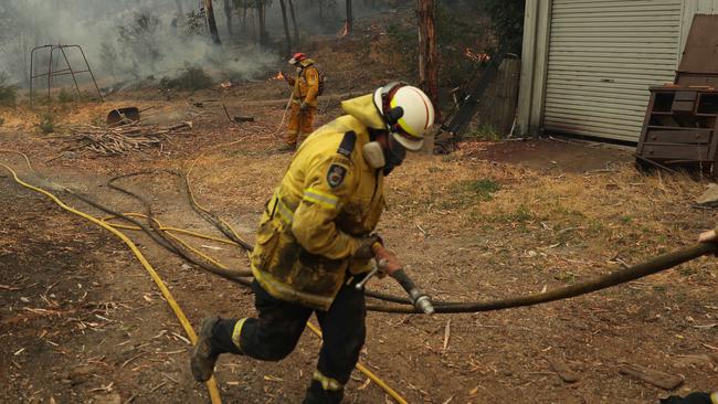 RFS fire crews working to save properties on Ivatt St in Cobar Park near Lithgow today. Picture: Tim Hunter