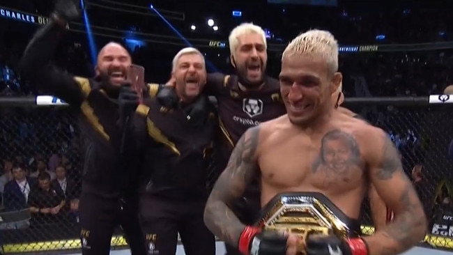 It’s a brave fan to steal something off the face of a UFC champion. Photo: Fox Sports
