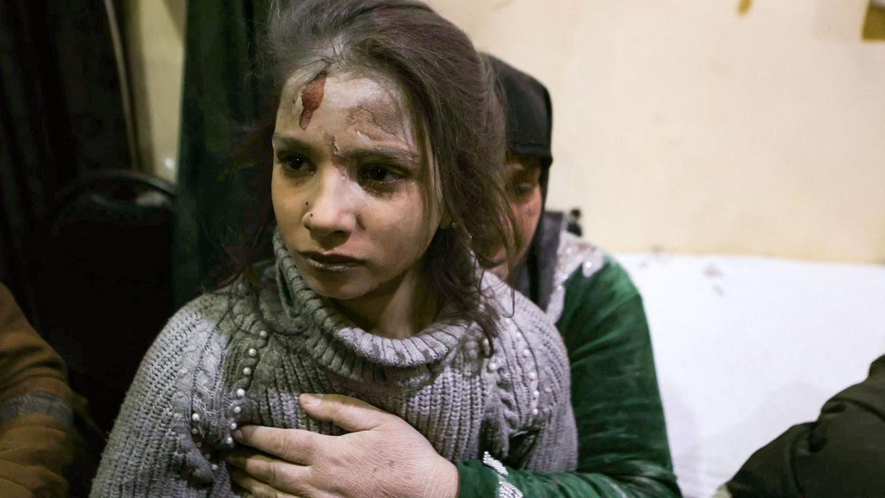 An injured young girl awaits treatment at a hospital following a pro-regime forces strike that targeted a neighbourhood in Syria's rebel-held northern city of Idlib. Picture: Aaref Watad/AFP