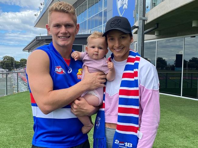 Kim Ravaillion alongside husband and Western Bulldog player Adam Treloar, and daughter Georgie.