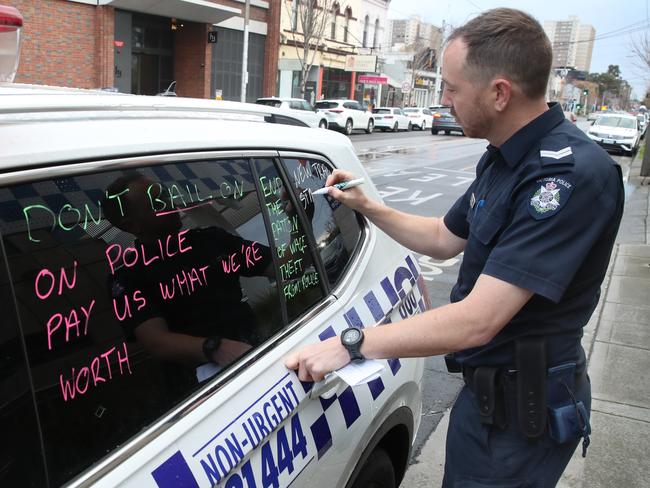 Police action for more pay begins today.  Police write messages on police vehicles at Richmond police station.Thursday, September 5. 2024. Picture: David Crosling