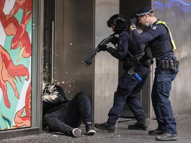 Police fire tear gas at a protester. Picture: Jason Edwards