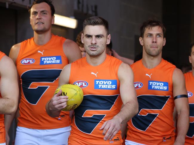 PERTH, AUSTRALIA - APRIL 09: Stephen Coniglio of the Giants leads the team out onto the field during the round four AFL match between the Fremantle Dockers and the Greater Western Sydney Giants at Optus Stadium on April 09, 2022 in Perth, Australia. (Photo by Paul Kane/Getty Images)