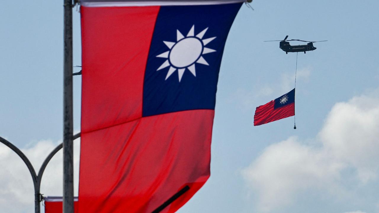 A CH-47 Chinook helicopter carries a Taiwan flag during national day celebrations in Taipei on the weekend. Picture: Sam Yeh/AFP