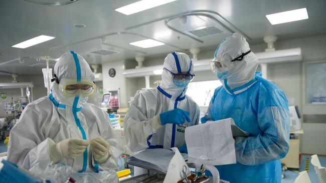 Medical staff checking notes in an intensive care unit treating COVID-19 coronavirus patients at a hospital in Wuhan, in China's central Hubei province. Picture: STR/AFP)