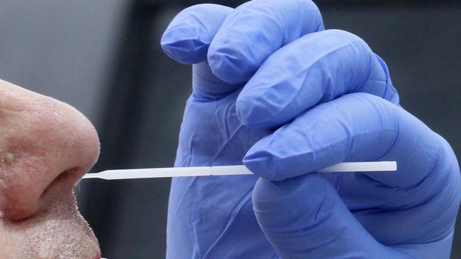 A health worker administers a coronavirus test. Picture: Rick Bowmer/AP