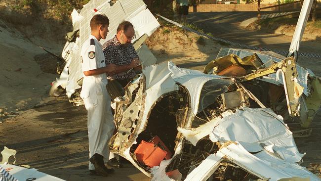 Air crash Bureau of Air Safety Investigator, John De Ruyter and Police investigator with plane wreckage at Currumbin Beach, Gold Coast. Picture: Riley Paul