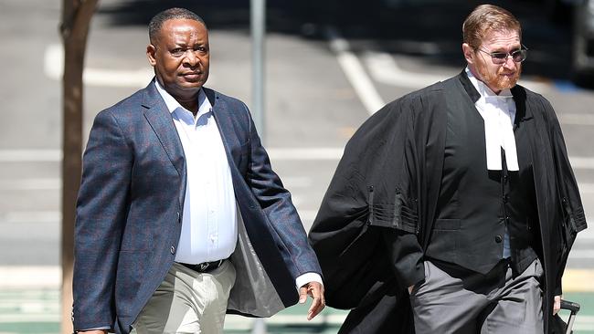 Doctor Olajide Ogunseye arrives at Brisbane District Court with his barrister Angus Edwards. Picture: Liam Kidston.