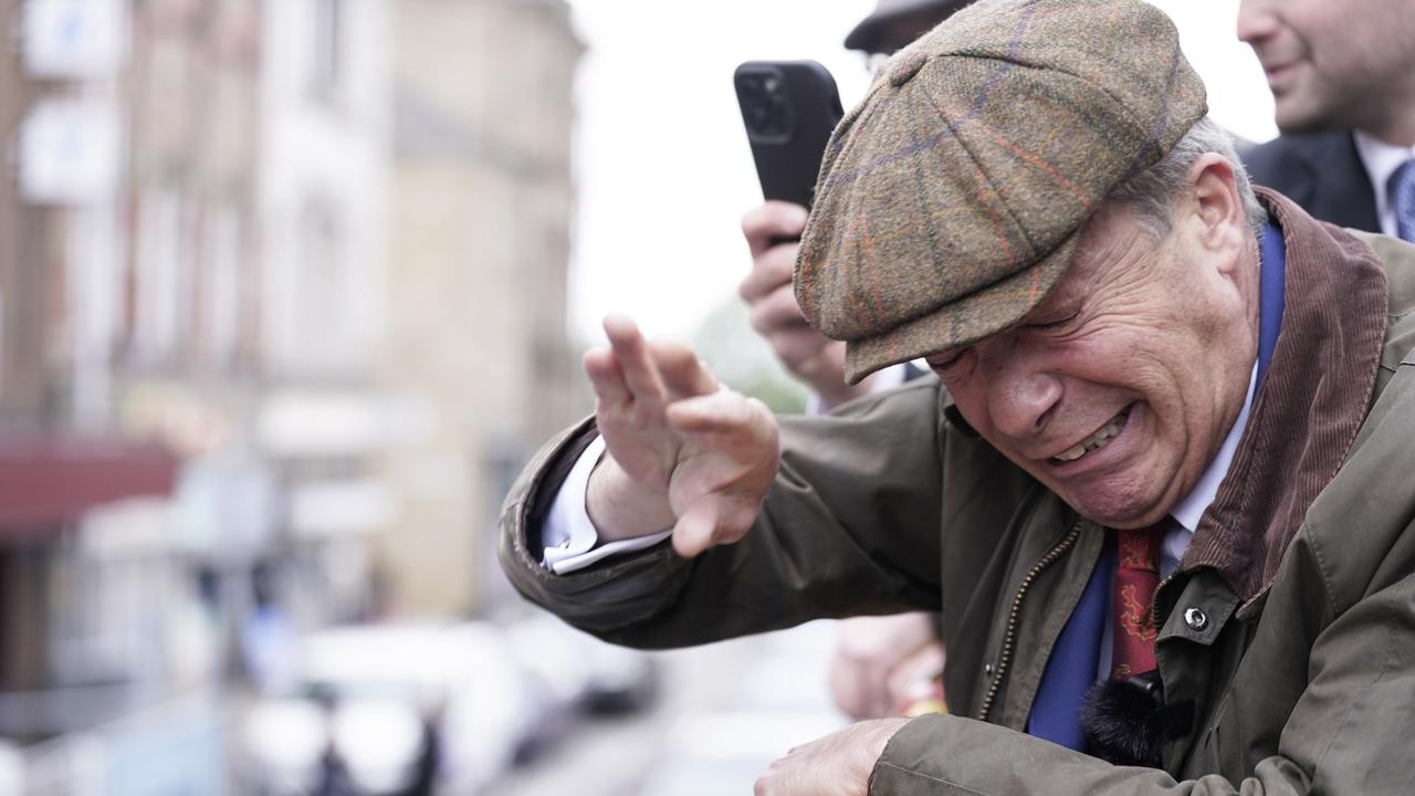 Reform UK leader Nigel Farage reacts after something is thrown towards him on the Reform UK campaign bus in South Yorkshire, while on the campaign trail. Picture: /PA Images via Getty Images