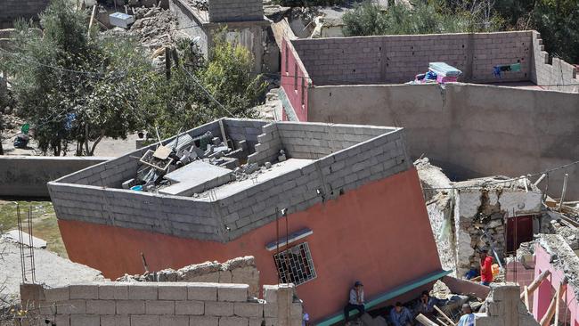 Residents search through the rubble of a home in Imoulas village of the Taroudant province, as Moroccan rescuers supported by newly-arrived foreign teams face an intensifying race against time to dig out any survivors. Picture: AFP