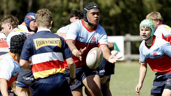 Illiyaz Villamu passes the ball. U15 Baxter  (Red) v U15 Gavin  (Orange).  Rugby Union Next Gen Cup for Under 15s and U14s. Picture: John Appleyard