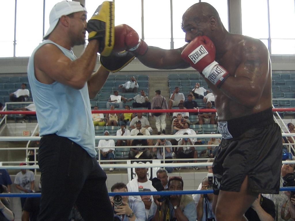 Jeff Fenech holds the pads for Mike Tyson.