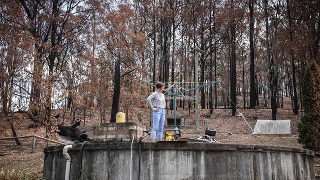 Sara Haslinger standing in front of the charred remains of her house in Exeter. Picture: Flavio Brancaleone