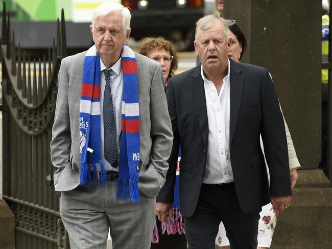 Mourners don Western Bulldogs scarfs. Picture: Andrew Henshaw