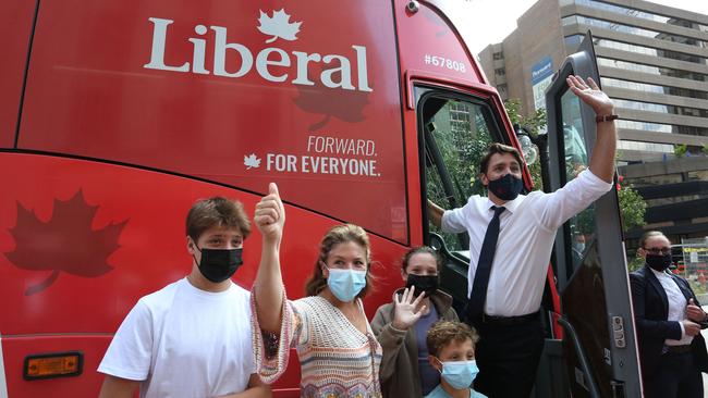 Canada's Prime Minister Justin Trudeau, his wife Sophie Gregoire Trudeau and their children, from left to right, Xavier, Ella-Grace and Hadrien, wave to supporters while boarding his campaign bus in Ottawa, Canada. Picture: AFP