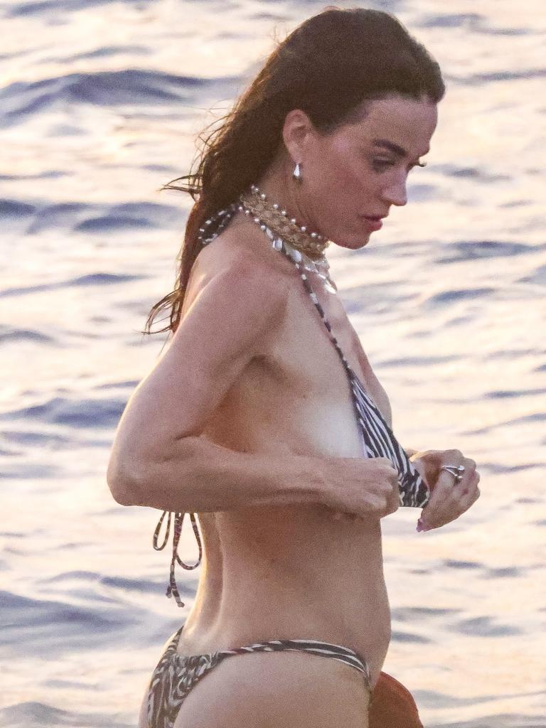 The pop singer wore an animal print bikini as she waded through the ocean. Picture: SPLASH / BACKGRID