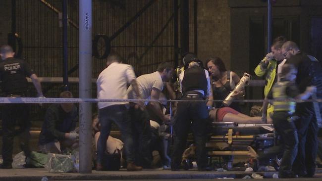 People are treated for their injuries Thrale Street near London Bridge. Picture: AP