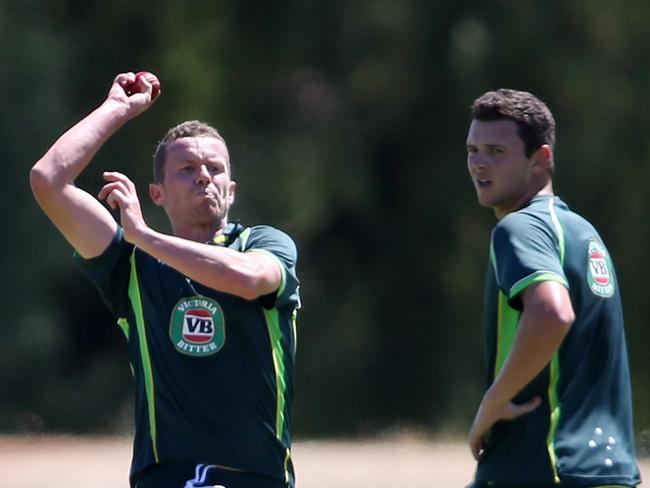 Josh Hazlewood looks on as Siddle bowls in practice early in Hazlewood’s career.