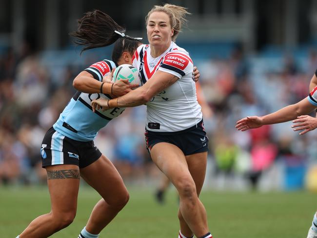 SYDNEY, AUSTRALIA - SEPTEMBER 08: Isabelle Kelly of the Roosters is tackled during the round seven NRLW match between Cronulla Sharks and Sydney Roosters at PointsBet Stadium on September 08, 2024 in Sydney, Australia. (Photo by Mark Metcalfe/Getty Images)