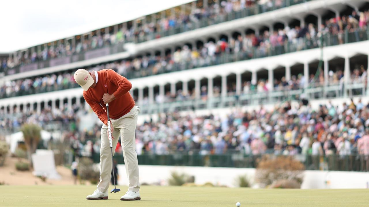 Adam Scott putts in front of packed stands in Phoenix. (Photo by Christian Petersen/Getty Images)