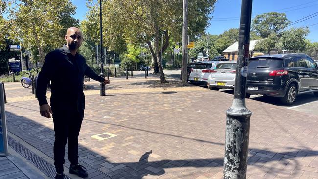 Daniel Stephens, the owner of Full Moon Thai in Erskineville pointing to where the toilets have been proposed from the corner of his restaurant's outdoor eating area. Photo: Odessa Blain.