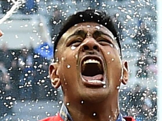 TOPSHOT - The champagne is sprayed as Saracens' players including Saracens' New Zealand born Australian lock Will Skelton (C) celebrate their win on the field after the European Rugby Champions Cup final match between Leinster and Saracens at St James Park stadium in Newcastle-upon-Tyne, north east England on May 11, 2019. - Saracens won a third European Champions Cup title in four years with a 20-10 win over Leinster on Saturday. (Photo by Glyn KIRK / AFP)