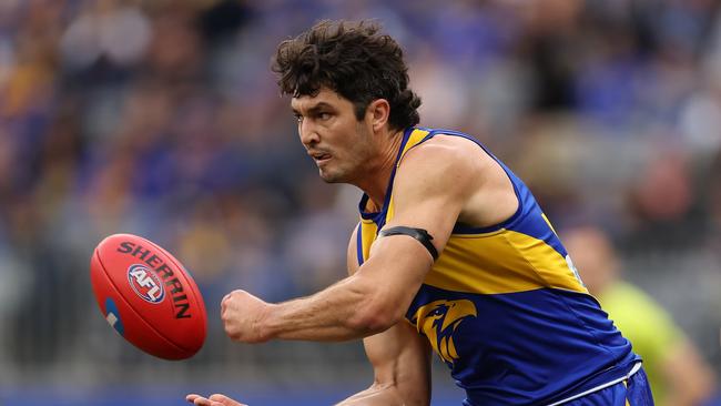 PERTH, AUSTRALIA - JUNE 08: Tom Barrass of the Eagles handballs during the round 13 AFL match between West Coast Eagles and North Melbourne Kangaroos at Optus Stadium, on June 08, 2024, in Perth, Australia. (Photo by Paul Kane/Getty Images)