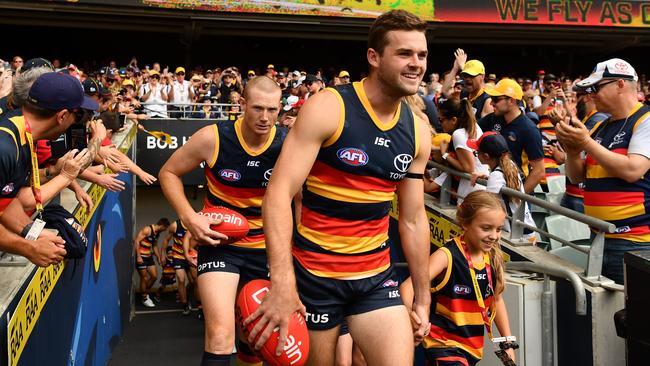 Brad Crouch runs out onto Adelaide Oval ahead of the season-opener against the Hawks.