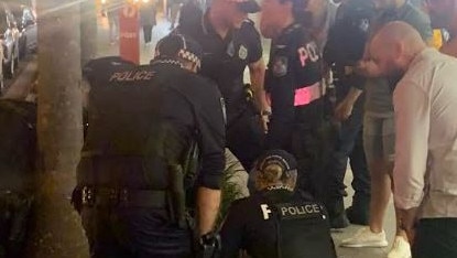 Police and paramedics attend two patrons involved in a fight with Cali Beach Club security outside the venue on Surfers Paradise Boulevard near the corner with Elkhorn Avenue just after 10.30pm.