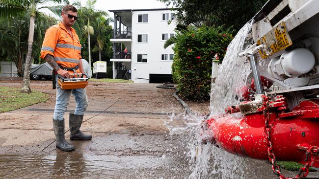 Geoff Fahey pumps out the underground car park at one of the many hotels flooded in Hervey Bay. Photo Paul Beutel