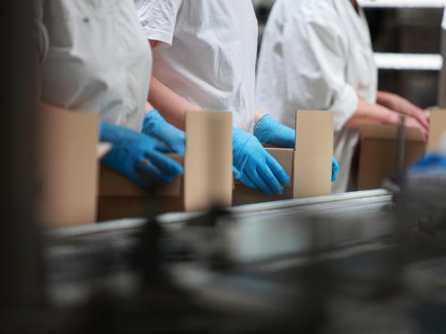 People working on packing line in factory - close up Picture: Istock