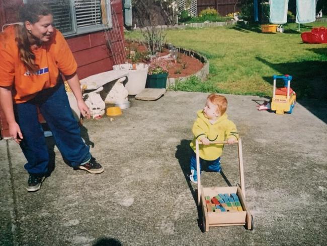 Tobias as a youngster in the yard of the family home with his “hands down best mum”, Tyrelle. Picture: Supplied